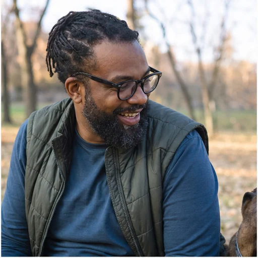 James laughing with a dog outdoors